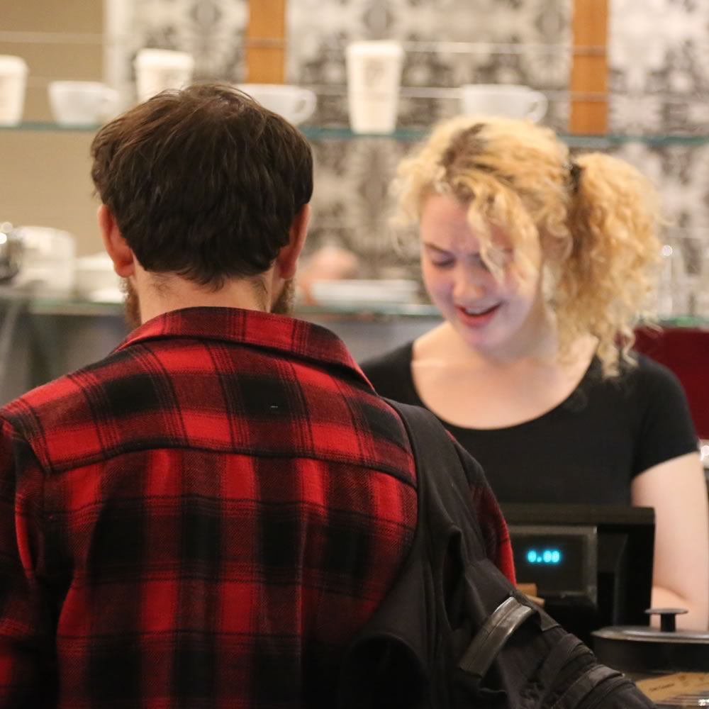 Barista serving customers at Tinderbox Byres Road, Glasgow